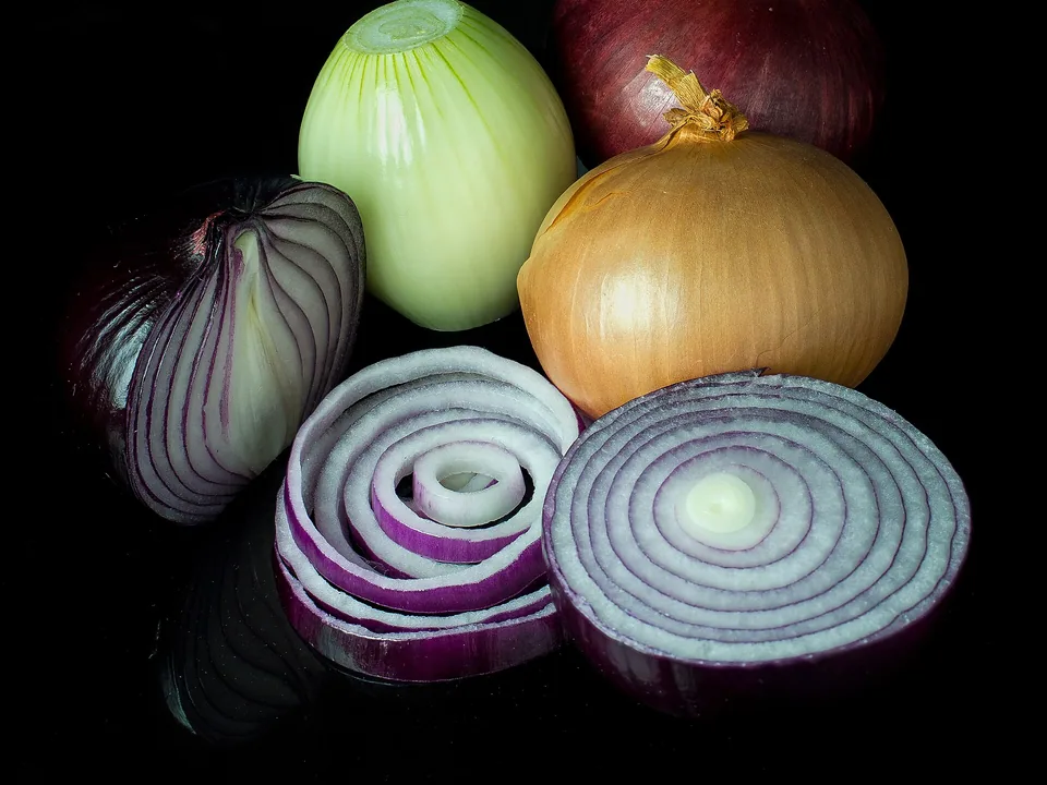 A mixed group of red, yellow, and white onions